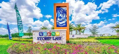 a sign for a store in a field with flowers at Go08 - STOREY LAKE in Kissimmee
