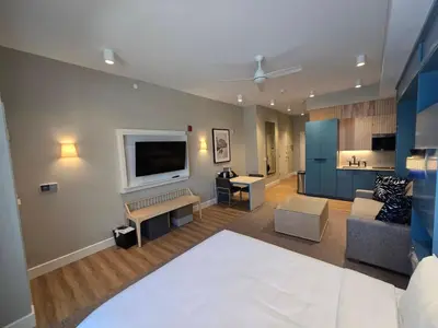 a living room with a couch and a flat screen tv at Go 29 Margaritaville Studio in Orlando