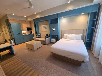 a bedroom with a large bed and a living room at Go 29 Margaritaville Studio in Orlando