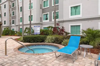 a patio with a chair and a table and a building at 1BR Suite Prime Orlando Location in Orlando