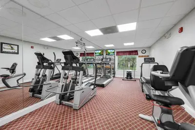 a gym with treadmills and elliptical machines at 1BR Suite Prime Orlando Location in Orlando
