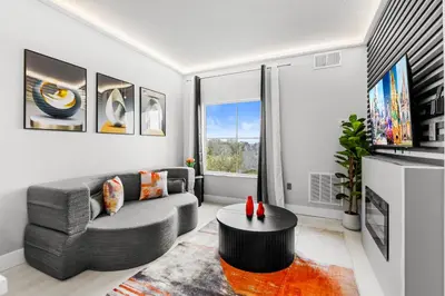 a living room with a couch and a table at 1BR Suite Prime Orlando Location in Orlando