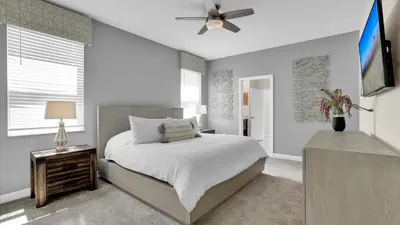 a bedroom with a bed and a ceiling fan at Parfect Paradise in Orlando
