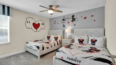 a bedroom with two beds and hearts on the wall at Parfect Paradise in Orlando