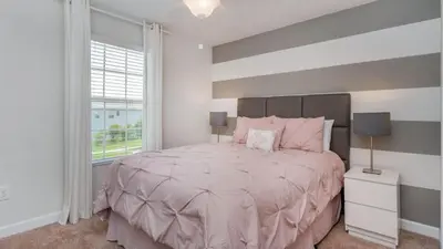 a bedroom with a large bed and a window at Storey Lake Villa in Kissimmee