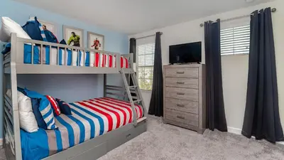 a bedroom with a bunk bed and a dresser at Storey Lake Retreat in Kissimmee