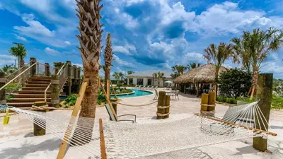 a resort with a hammock and a swimming pool at Storey Lake Retreat in Kissimmee