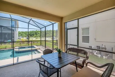 a living room with a table and chairs and a pool at Winterfield storeylake 2759 in Kissimmee