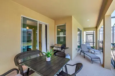 a porch with a wooden table and chairs and a patio at Winterfield storeylake 2759 in Kissimmee
