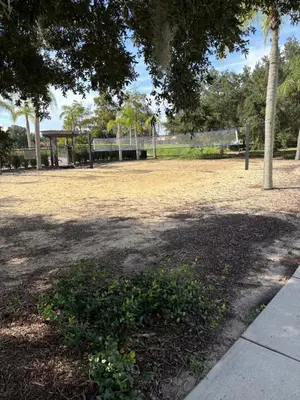 a park with a tree and a bench and trees at Resort 4 Br 3 Ba Private Pool Home & Lake View near Disney & Universal in Kissimmee
