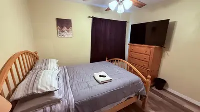 a bedroom with a bed and a dresser with a television at G7 Private Room with Smart TV Near Everything in Orlando
