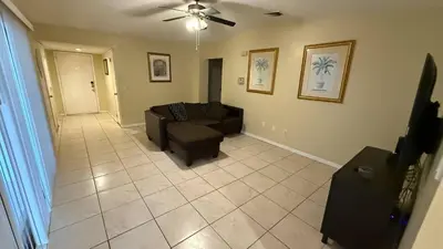 a living room with a couch and a ceiling fan at G7 Private Room with Smart TV Near Everything in Orlando