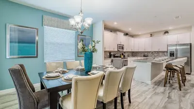 a dining room and kitchen with a table and chairs at The Sunshine Villa in Kissimmee