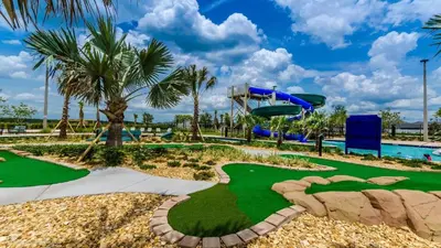 a miniature golf course at a resort with a slide at The Sunshine Villa in Kissimmee