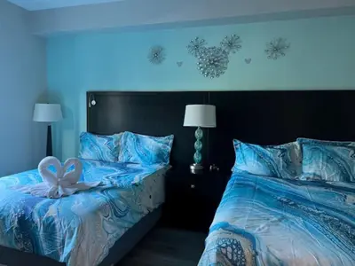 a bedroom with a bed with a bow on it at Aqua Condo-Free Shuttle-Disney-Universal EPIC in Orlando