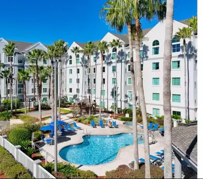 a view of a hotel with a pool and palm trees at Condo-Free Shuttle-Disney-Universal Epic in Orlando