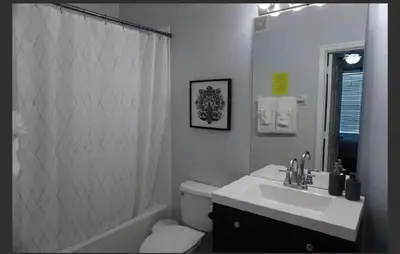 a bathroom with a sink and a toilet and a shower at Apartment near Disney & UniversalEpic in Orlando