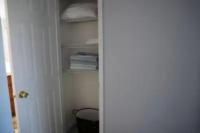 a closet with a door open with towels at Apartment near Disney & UniversalEpic in Orlando