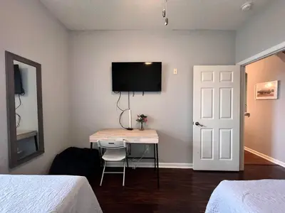 a room with a desk and a tv on a wall at Condo Disney Universal Epic Pool in Kissimmee