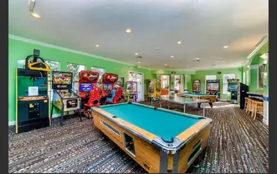 a room with a pool table and arcade games at Condo Disney Universal Epic Pool in Kissimmee