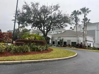 a house with a tree in the middle of a street at Condo near Disney Springs-Free shuttle to Parks in Orlando