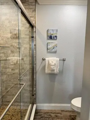 a bathroom with a shower stall and a toilet at Condo Near Disney-Universal-Epic-Sea World in Orlando