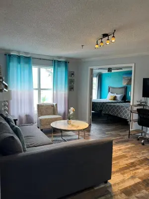 a living room with a couch and a table at Condo Near Disney-Universal-Epic-Sea World in Orlando