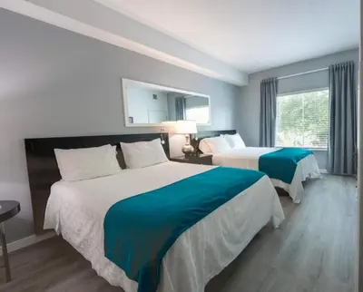 a hotel room with two beds and a window at Inspiration condo near Disney with free shuttle in Orlando