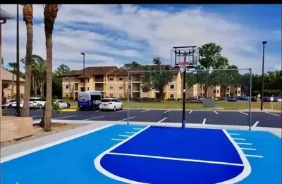 a basketball court in a parking lot with a basketball hoop at Condo 2 Queen beds-Disney-Universal in Orlando