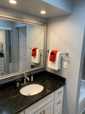 a bathroom with a sink and a mirror and towels at Condo 2 Queen beds-Disney-Universal in Orlando