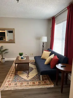 a living room with a blue couch and a table at Condo near Disney Universal Free Parking in Orlando