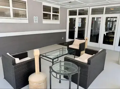 a room with two chairs and a glass table at Condo near Disney Universal Free Parking in Orlando