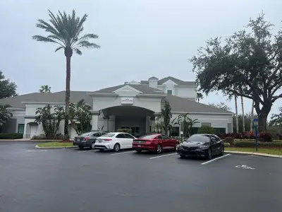 a group of cars parked in front of a building at Renovated Condo near Disney Free Shuttle to Parks in Orlando