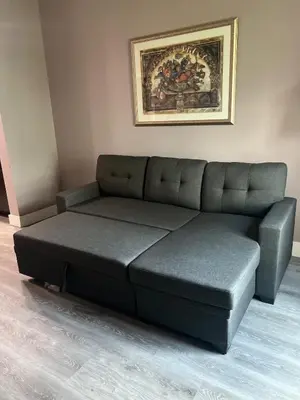 a leather couch in a room with a painting on the wall at Renovated Condo near Disney Free Shuttle to Parks in Orlando