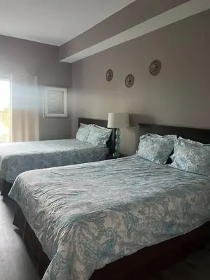 a bedroom with two beds and a window at Renovated Condo near Disney Free Shuttle to Parks in Orlando