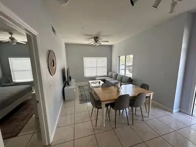 a dining room and living room with a table and chairs at Renovated 4 bed3 bath Townhome near Disney in Kissimmee
