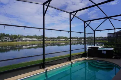 a swimming pool with a view of a lake at Villa near Disney Jacuzzi Pool 4bed-3baths in Kissimmee