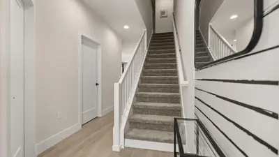 a staircase in a home with white walls and a stair case at Contemporary 4BR Townhome with Pool & Themed Rooms in Orlando