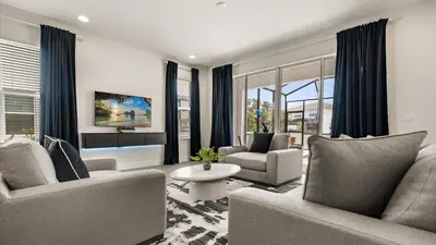 a living room with a couch and chairs and a table at Contemporary 4BR Townhome with Pool & Themed Rooms in Orlando