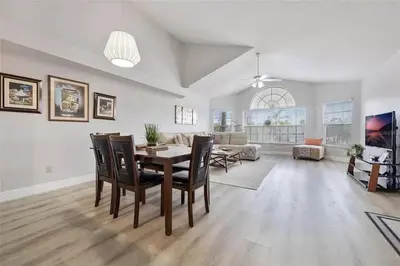 a large living room with a table and chairs at 3BR Condo Near Disney, with Clubhouse, Pool and Gym in Kissimmee