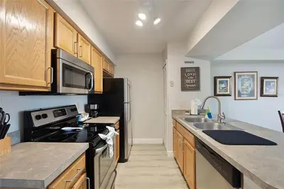 a kitchen with a sink and a stove top oven at 3BR Condo Near Disney, with Clubhouse, Pool and Gym in Kissimmee