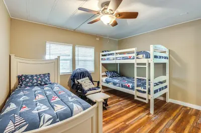 a bedroom with bunk beds and a ceiling fan at Lakefront Home with Hot Tub and Dock in Orlando! in Orlando