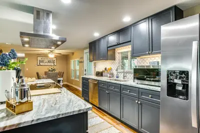 a kitchen with blue cabinets and a counter top at Lakefront Home with Hot Tub and Dock in Orlando! in Orlando