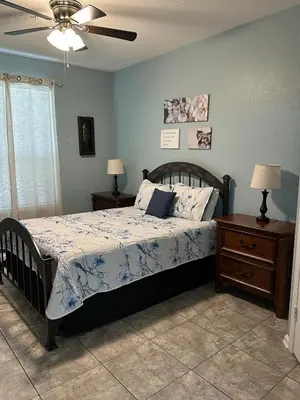 a bedroom with a bed and a ceiling fan at PalmTree Oasis 3 bedroom Condo at Windsor Hills in Orlando