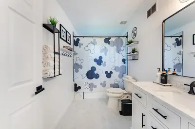 a bathroom with a toilet and a shower at Magical 3BR Luxury Condo - 15 Mins to Disney in Kissimmee