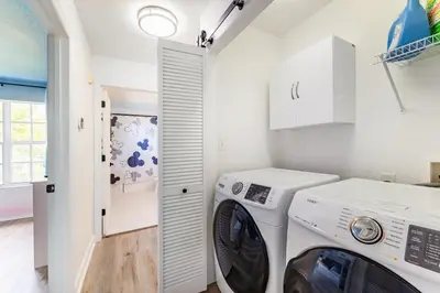 a laundry room with a washer and dryer at Magical 3BR Luxury Condo - 15 Mins to Disney in Kissimmee