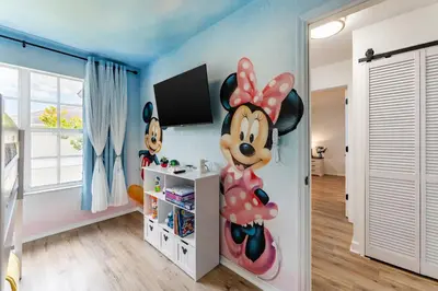 a bedroom with a mickey mouse mural on the wall at Magical 3BR Luxury Condo - 15 Mins to Disney in Kissimmee