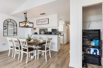 a kitchen and dining room with a table and chairs at Magical 3BR Luxury Condo - 15 Mins to Disney in Kissimmee