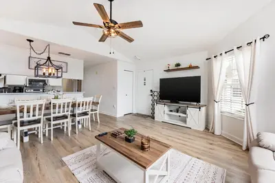 a living room with a couch and a tv and a table at Magical 3BR Luxury Condo - 15 Mins to Disney in Kissimmee