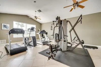 a gym with treadmills and cardio equipment in a room at Kissimmee Resort-Style Home Close to Shops and Eats in Kissimmee